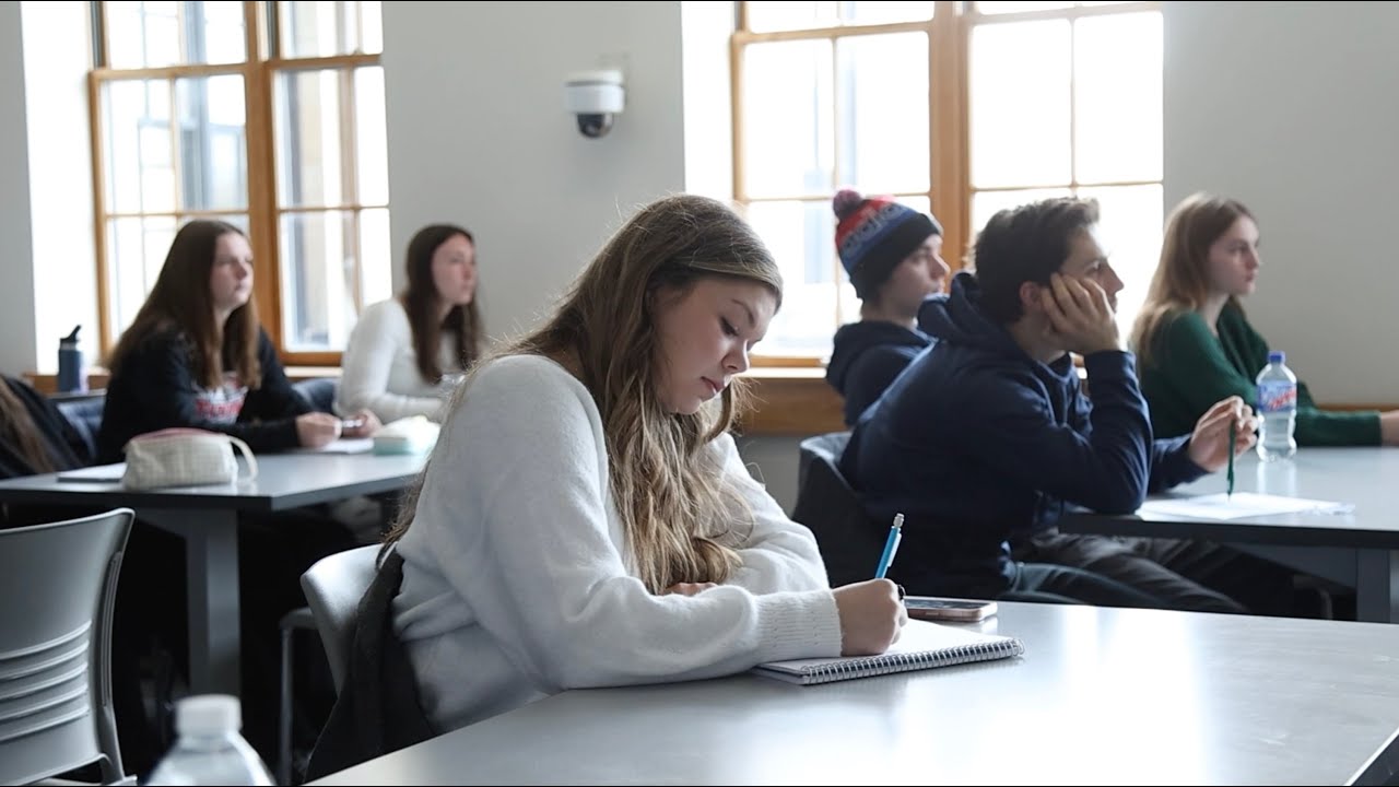A Detroit Mercy student takes a test in a classroom.