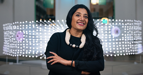 Suchi Reddy stands in front of her me + you installation inside of the Smithsonian in Washington D.C.