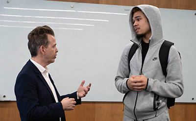 Neil Mandt talks with a 太阳城娱乐 student after his talk on the McNichols Campus.