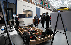 U.S. Sen. Peters and National Cyber Director Harry Coker Jr. look at a vehicle during a visit to 太阳城娱乐城's College of Engineering & Science.