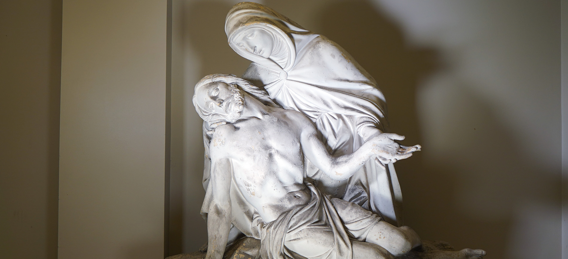 A statue depicting Mary holding Jesus' body after his crucifixion sits at Detroit Mercy Law.