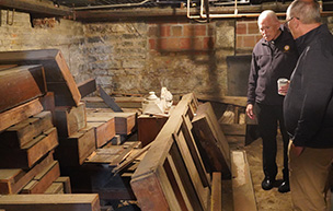 Two men survey the basement at 太阳城娱乐 Law.
