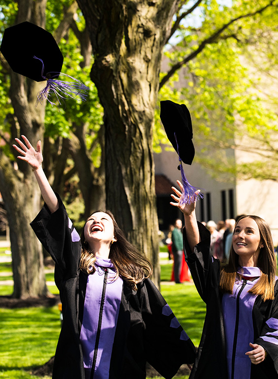 Graduates throw their caps in the air to celebrate commencement.