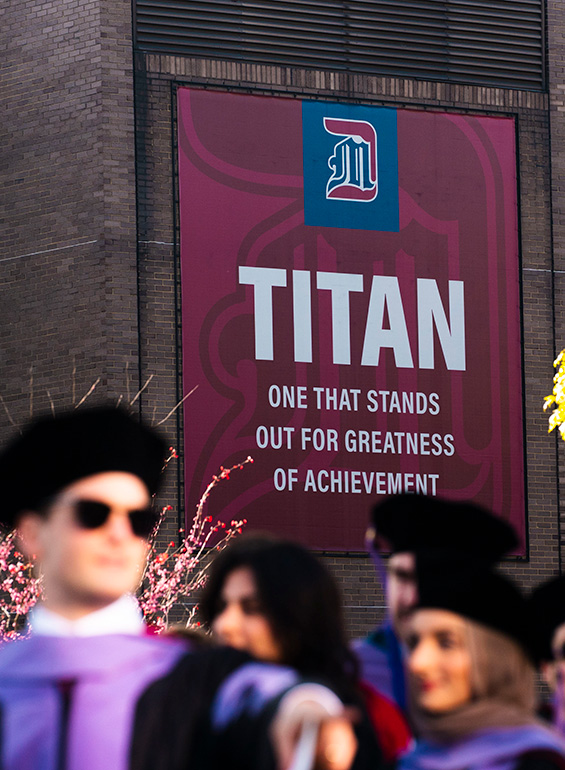 Graduates line up near the Titan sign that reads 
