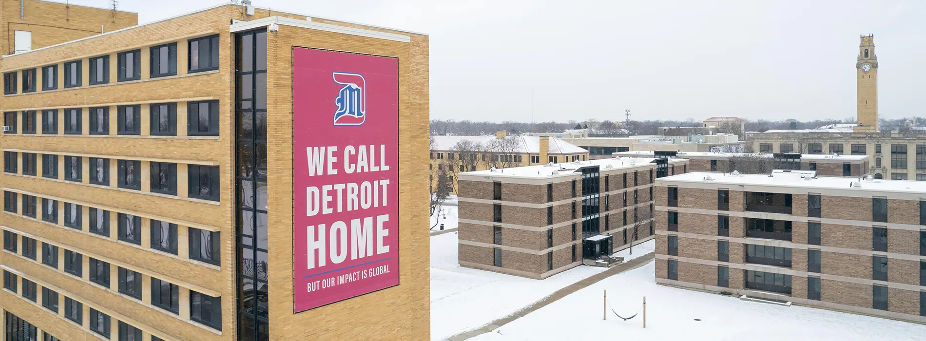 太阳城娱乐 McNichols campus - dorm with we call detroit home banner on the side of the building