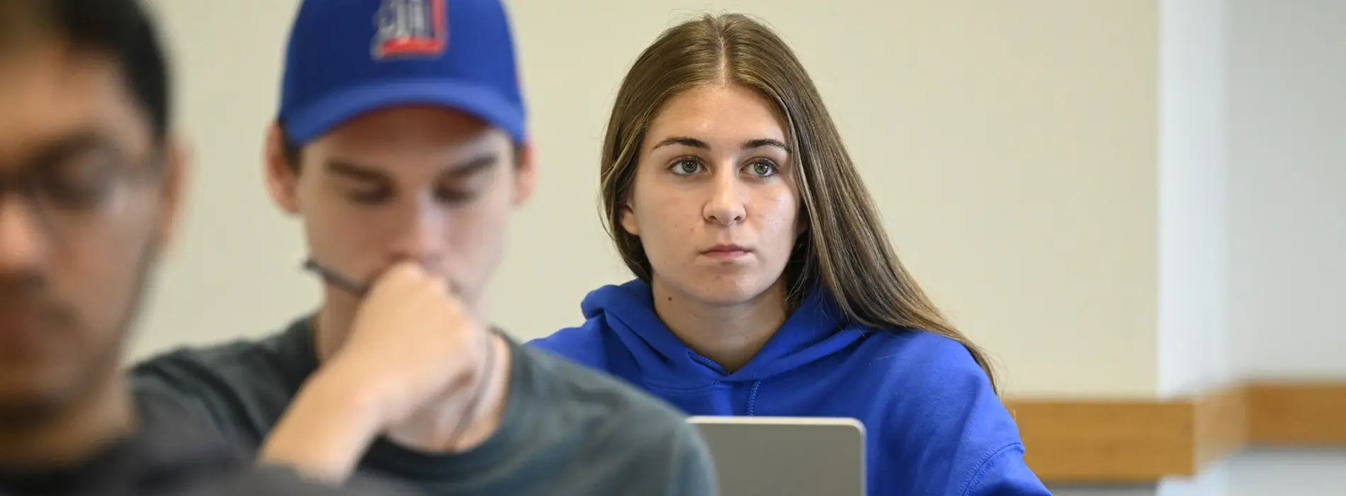 female student looking up but on her laptop