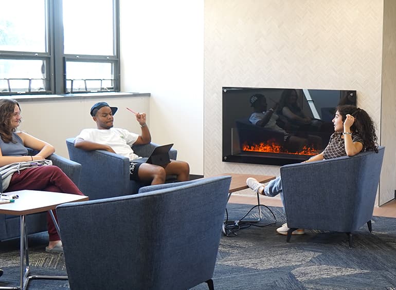 seated students by the fireplace in shiple