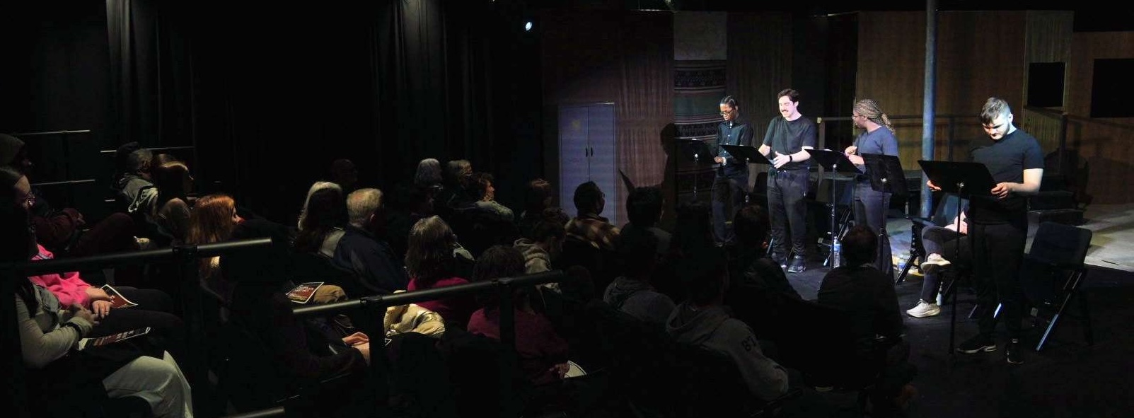 Image of actors on a stage and an audience