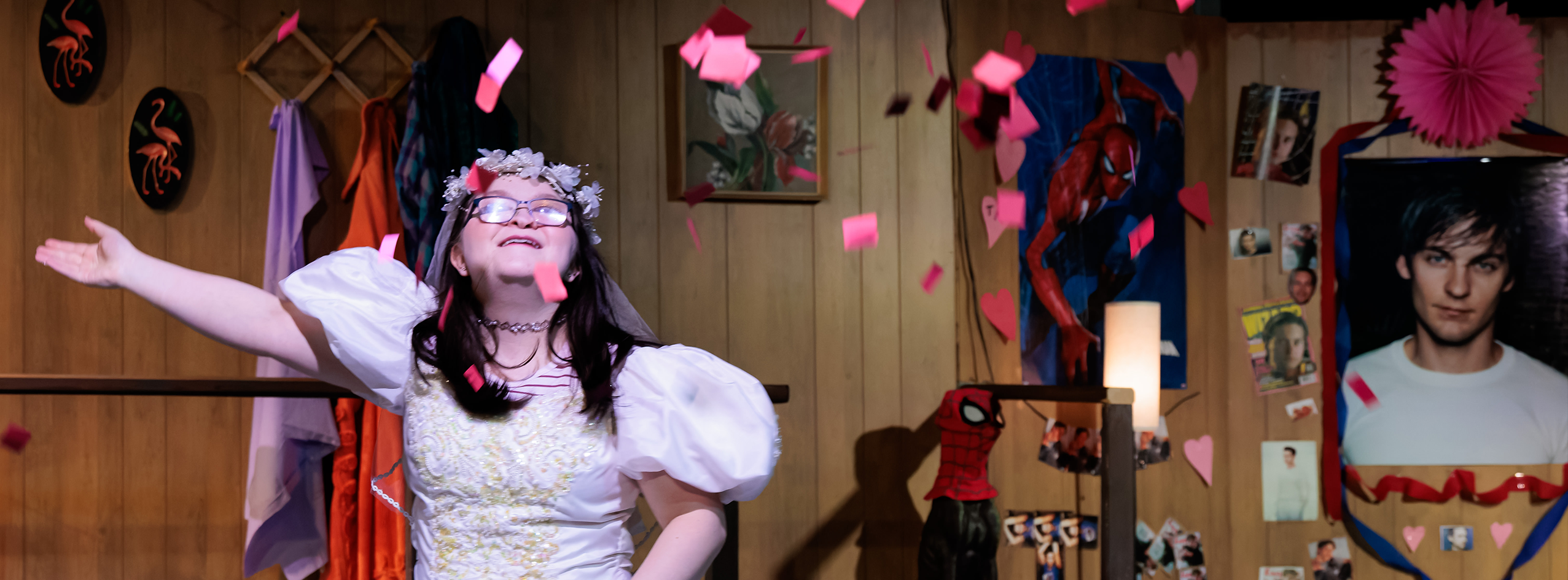 An actor in a wedding dress throws petals